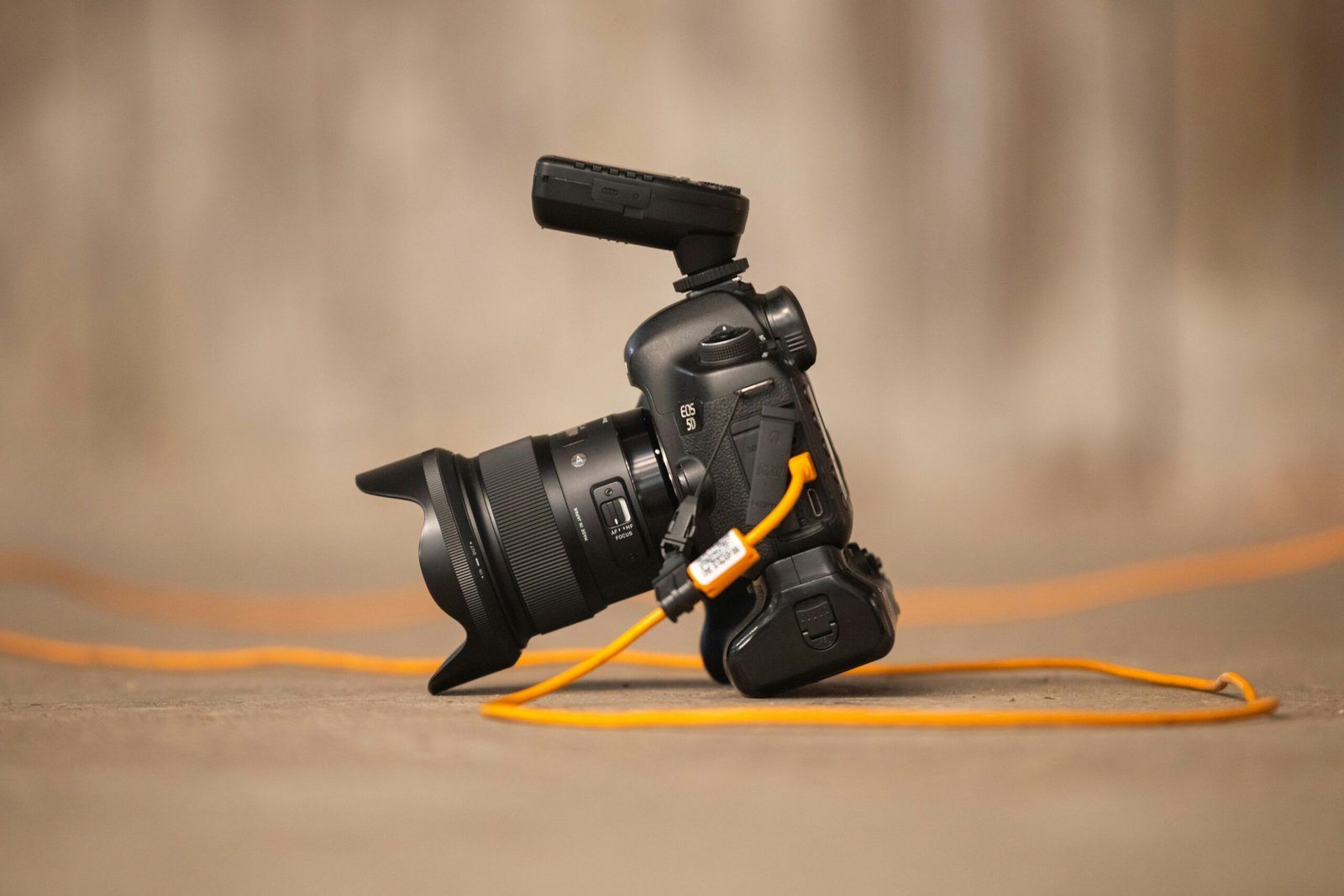 a camera with a yellow cord attached to it